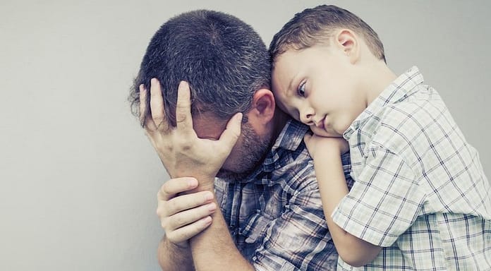 Son Hugging a dad feeling guilty