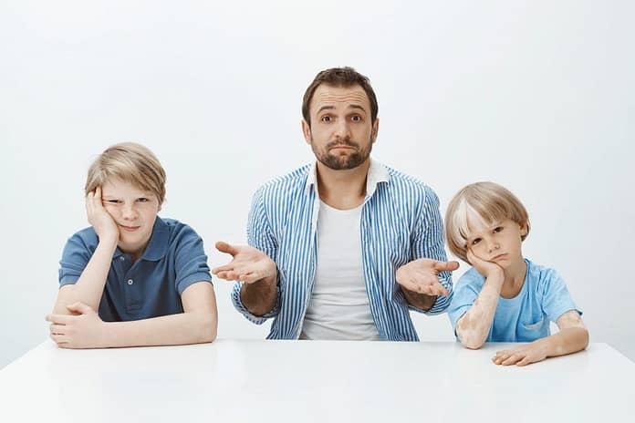 confused looking dad with children