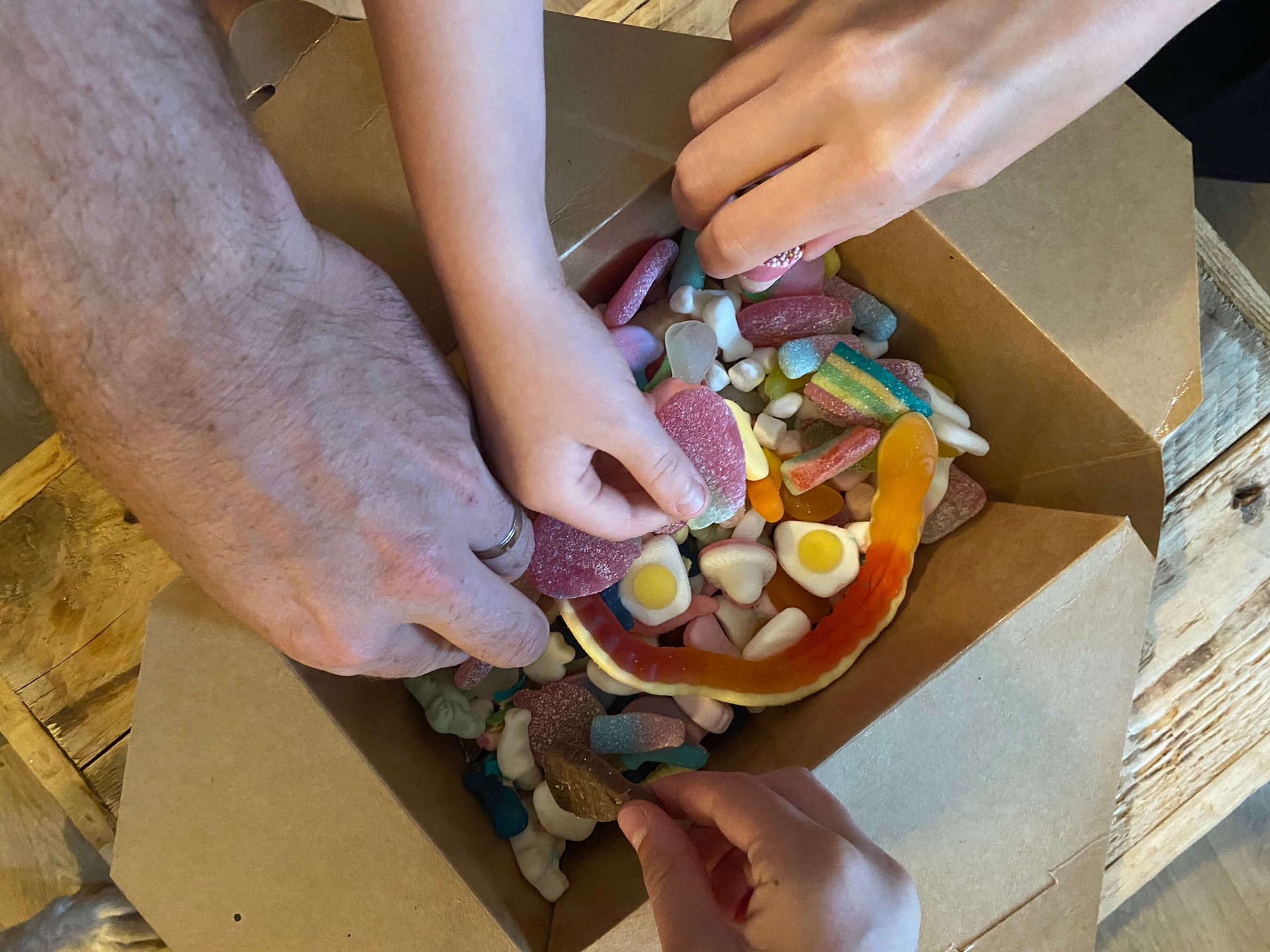 Family Taking Sweets From Pick N Mix Sweet Box